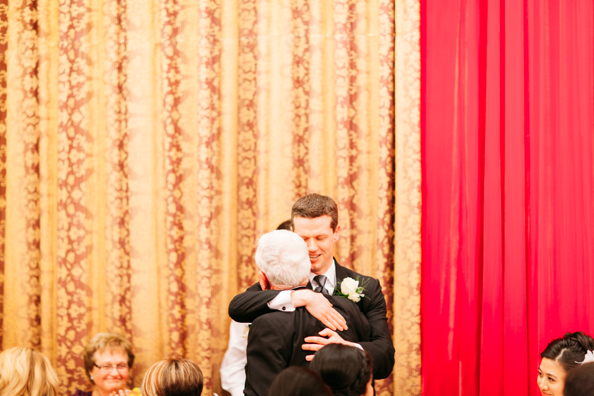 Groom hugging the father